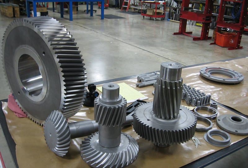 Gear train exposed during inspection; journal and tooth faces checked for wear.