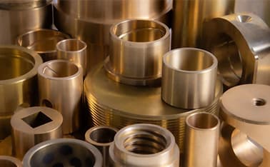 Team members inspecting finished bushings for defects and consistency.