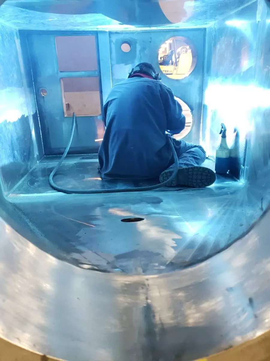 Hopper outlet with flange for easy connection to downstream equipment.